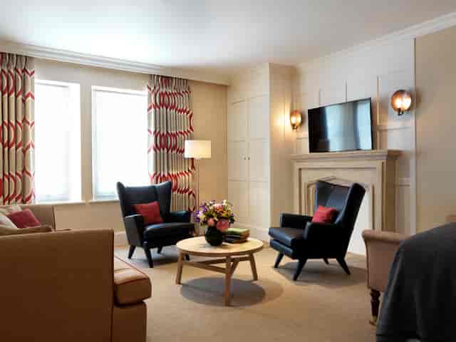 The Gatehouse meeting space in The Stafford London, featuring cozy seating and natural light.