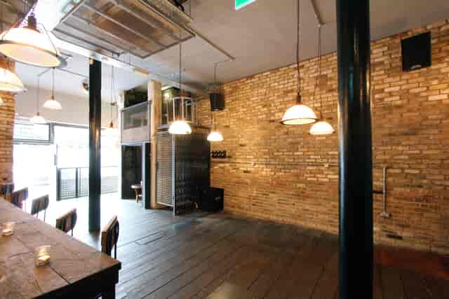 Industrial-chic Iron Bloom event space with raw brick walls for creative workshops and networking.