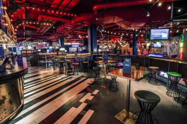Emerald Area at Puttshack White City, vibrant event space with piano key flooring.