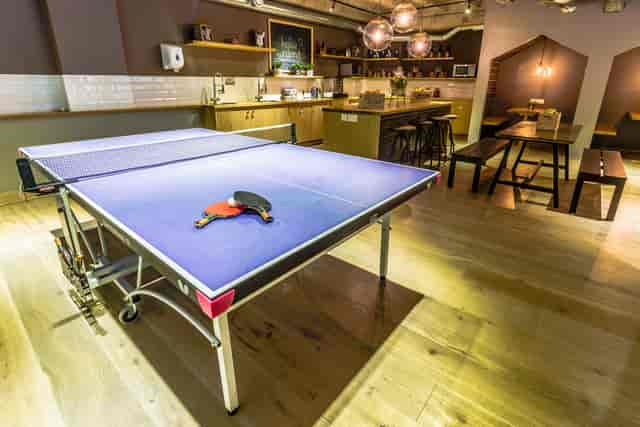 Modern cafe venue with ping pong table for team-building events and networking.
