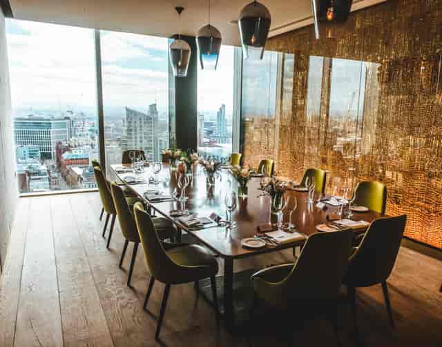 Private dining room with panoramic city view, ideal for corporate events and meetings.