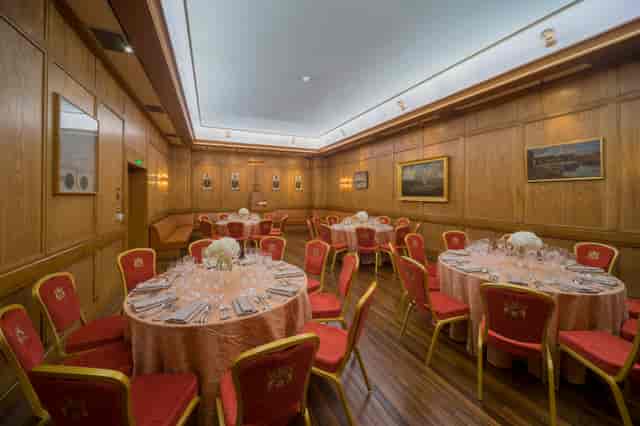 Elegant event space in Bakers' Hall with floral centerpieces, perfect for corporate gatherings.