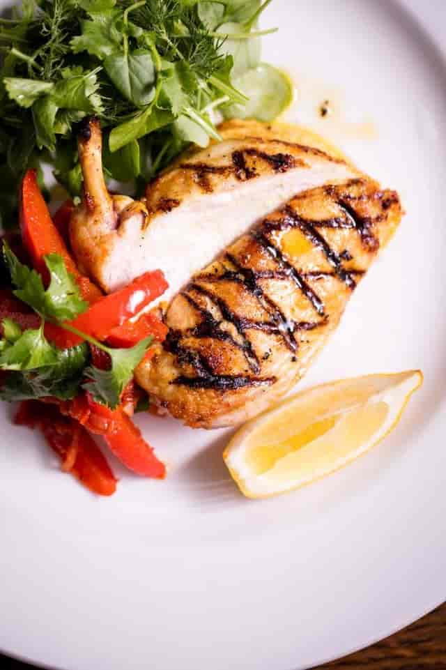 Grilled chicken breast with vibrant peppers at Apple Vault, Covent Garden event catering.
