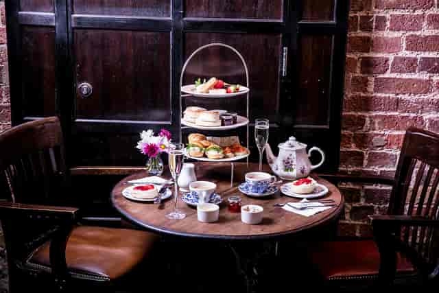 Elegant afternoon tea setup with pastries in Market Cellar, Covent Garden.