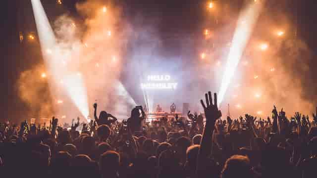 OVO Arena Wembley concert scene with vibrant lighting and packed audience energy.