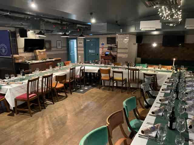 Cellar Bar dining setup with long table, ideal for corporate events and intimate gatherings.