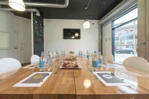 Meeting room with wooden table, natural light for productive meetings and presentations.