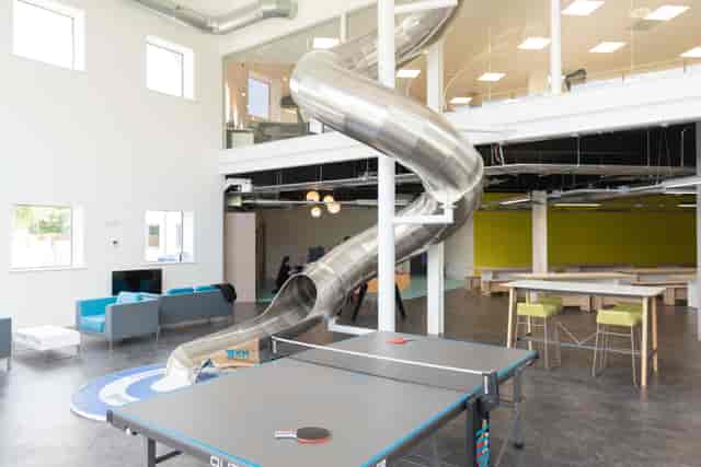 Modern board room with slide, perfect for team-building and brainstorming events.