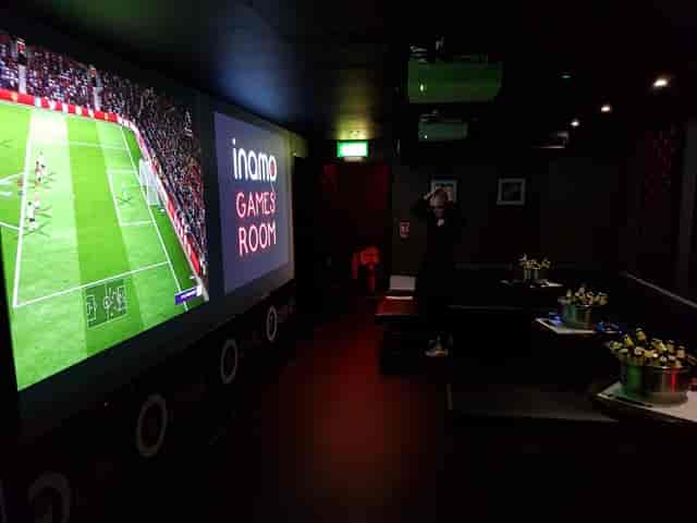 Vibrant game room with large screen for team-building events and casual gatherings.