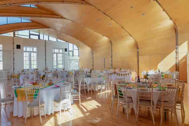 Spacious Siobhan Davies Studios event venue with wooden arches, ideal for weddings and gatherings.