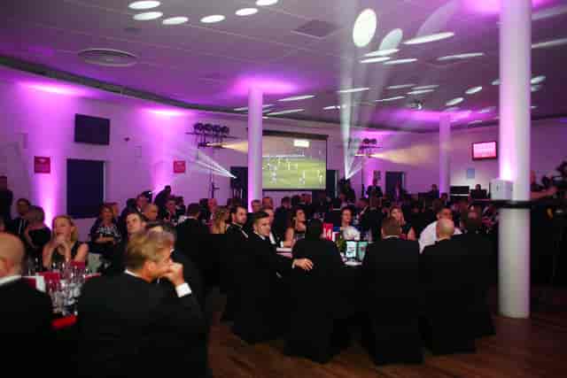 Chris Robshaw Bar gala event with elegantly dressed guests and purple ambient lighting.