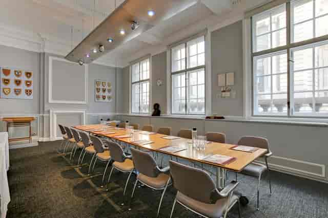 Frank Whittle in a bright, minimalist meeting room for professional events.