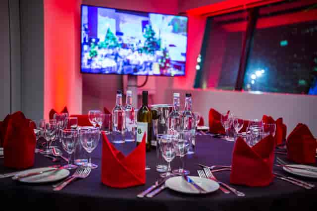 Elegant dining setup with red napkins at Imperial War Museum North event.