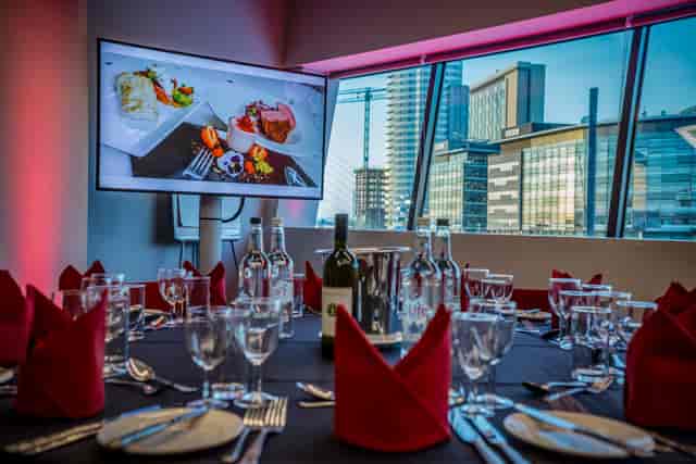 Elegant dining setup at WaterShard, Imperial War Museum North for corporate events.
