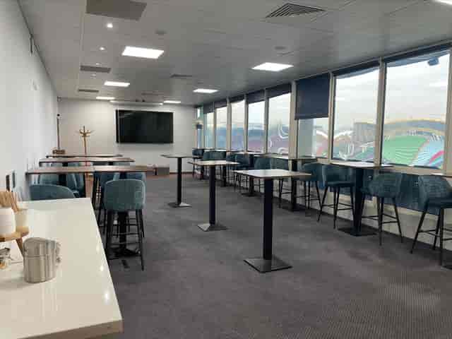 Modern event space at Twickenham Stoop with large windows, ideal for networking and presentations.