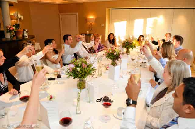 Celebratory gathering in Garden Room 3 with elegant table settings and floral centerpieces.