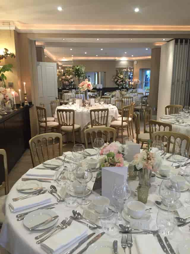 Elegant event space with round tables, ideal for weddings and corporate gatherings.
