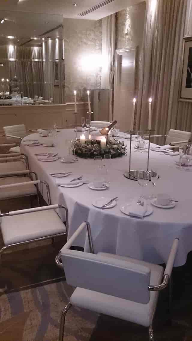Elegant round table setting with floral centerpiece at Hard Days Night Hotel event.
