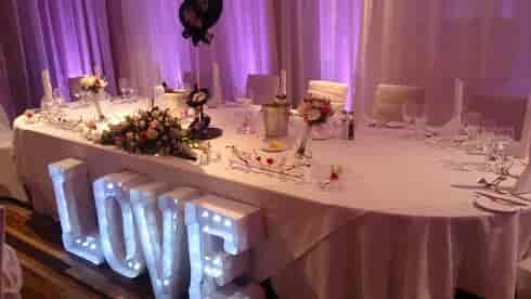 Zygmant Suite with romantic table setting and "LOVE" sign for weddings and gatherings.