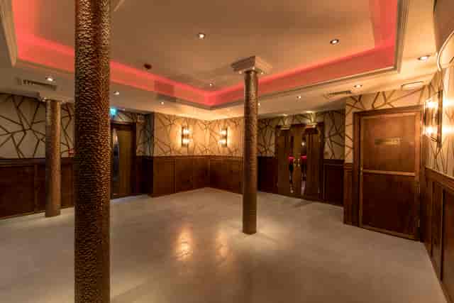 Modern event space with polished flooring for networking or corporate gatherings.