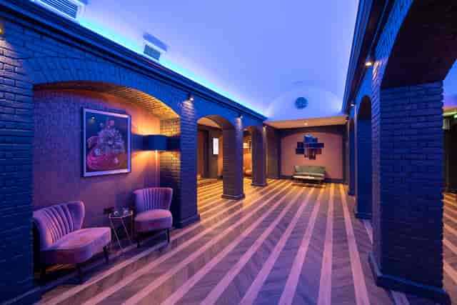 Stylish event space with elegant arches, ideal for meetings and networking gatherings.