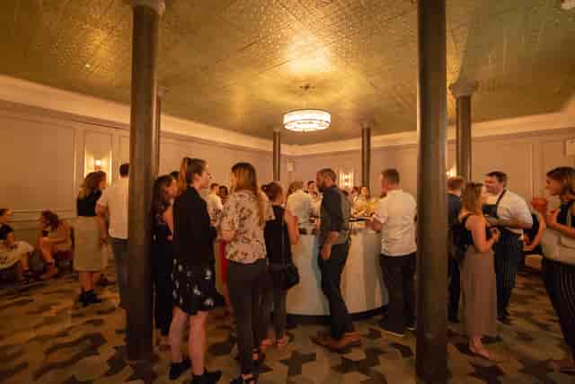 Vibrant networking event in The Pasteur Room, stylish decor, comfortable seating.