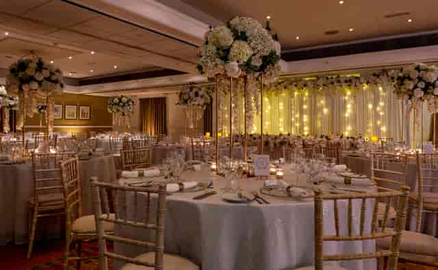 Elegant banquet hall with floral centerpieces for weddings and corporate events.