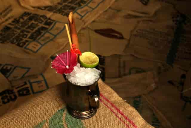 Vibrant cocktail with umbrella at PITCH Stratford event venue, enhancing guest experience.