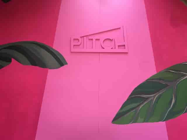Vibrant PITCH venue with pink walls, ideal for networking events and product launches.