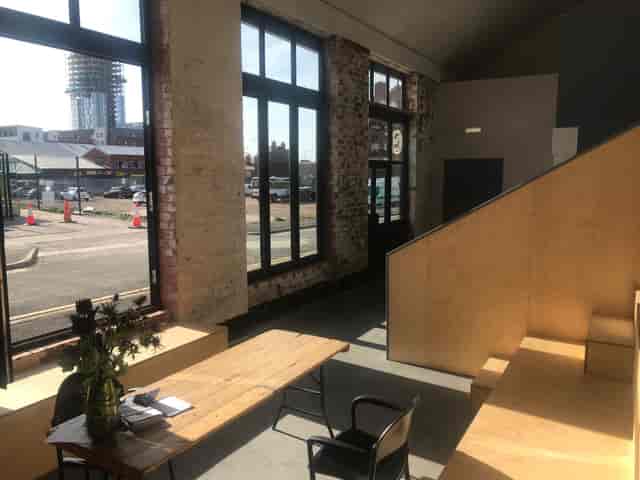 "Versatile event space with large windows for meetings and workshops in Hinterlands."