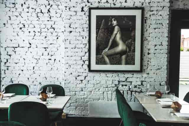Stylish Robata Grill with exposed brick and green seating, perfect for upscale events.