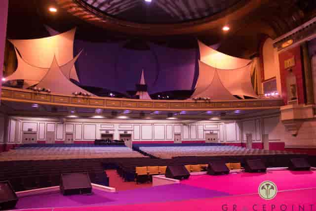 Spacious GRACEPOINT venue with elegant stage, perfect for conferences and performances.
