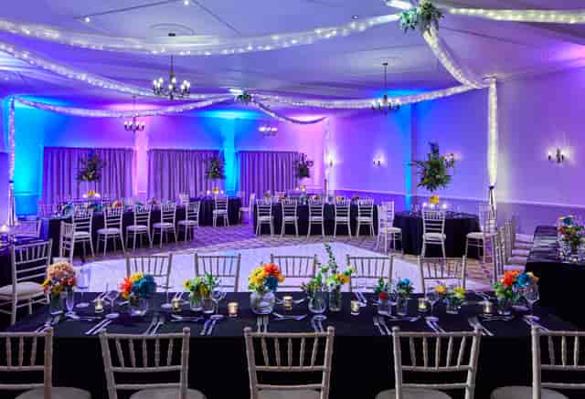Elegant Broughton Suite event space with floral centerpieces for formal gatherings.