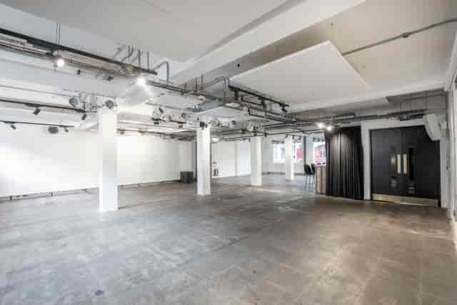 Industrial-chic White Space venue with lighting rig for experiential events and brand launches.