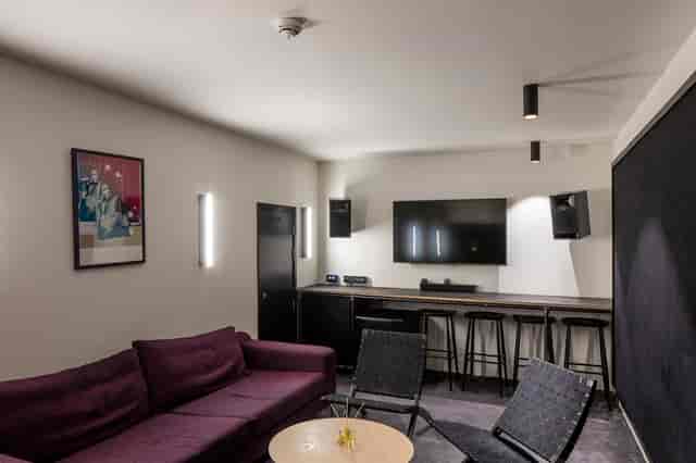 Modern huddle room at The Studio in The Ministry for hybrid meetings and corporate strategy sessions.