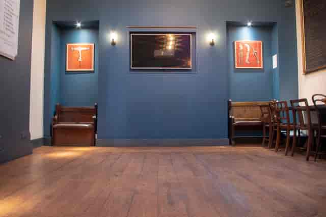 Modern event space with blue walls, ideal for meetings and gatherings.