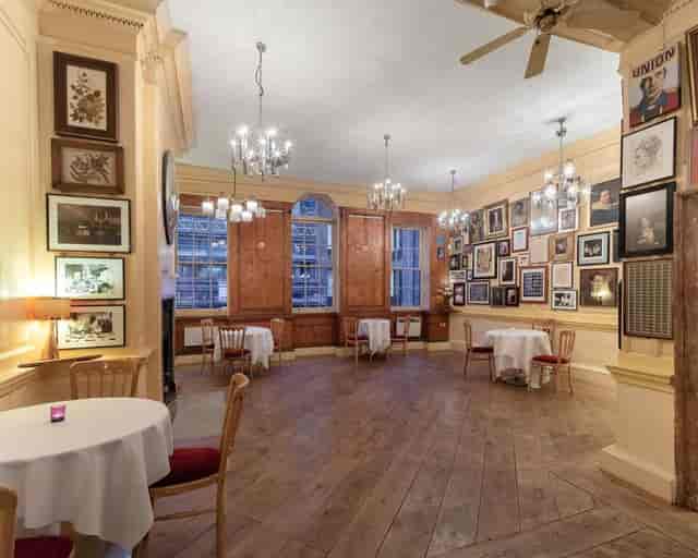 Elegant dining room with chandeliers, perfect for receptions and gatherings.