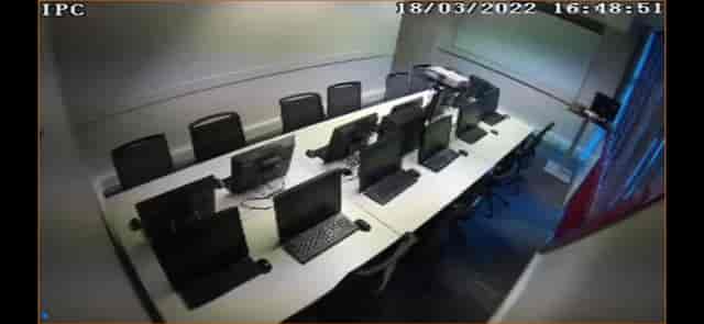 Modern meeting room with computer stations for hybrid training events.