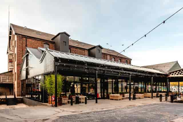 Wedding venue with large glass windows and outdoor space for unique events.
