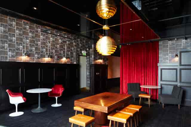 Stylish event space in Everyman Leeds with gold pendant lighting for upscale gatherings.
