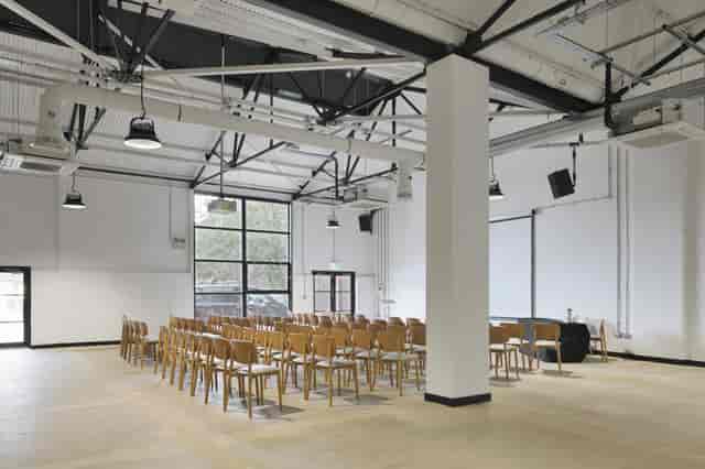 Versatile event space at Gatehouse, featuring high ceilings for corporate meetings and workshops.