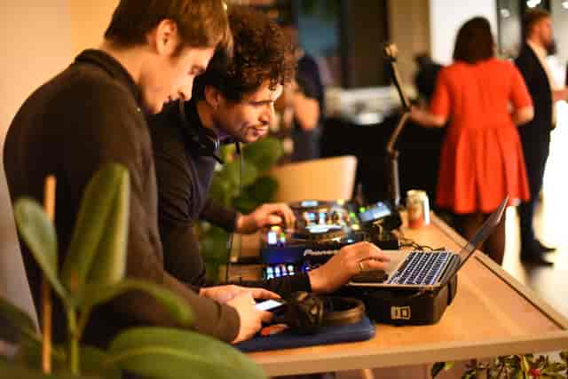 DJs collaborating at Cafe Lounge event, creating a lively atmosphere with engaging audio.