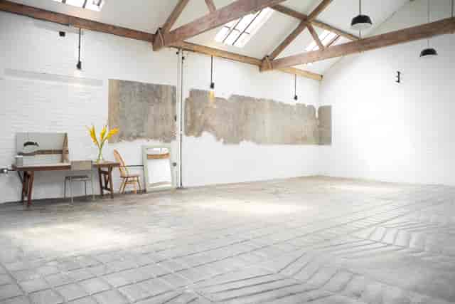 Versatile event space with exposed beams, ideal for workshops and meetings.