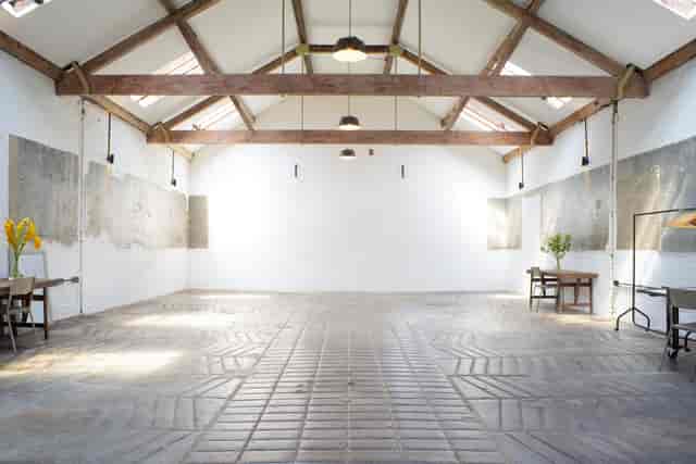 Spacious event venue with high ceilings, ideal for corporate meetings and workshops.