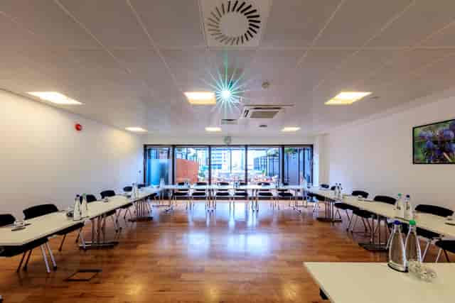 Juniper Room meeting space in Docklands with hardwood floors, perfect for workshops and board meetings.