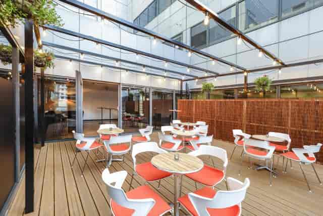 Modern Juniper Room terrace with bistro seating for networking events and corporate meetings.