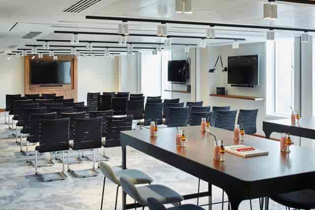 Modern meeting space at London Heathrow Marriott with sleek chairs for workshops.