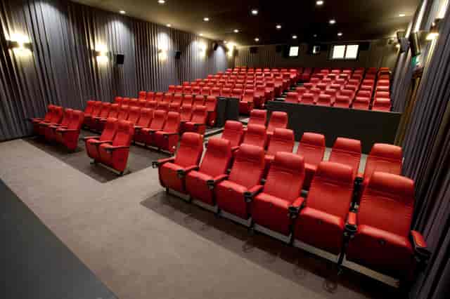 Modern auditorium with red seating at Barbican Centre for presentations and screenings.