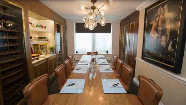 The Wine Room at The Ampersand Hotel, featuring a long wooden table for intimate meetings.