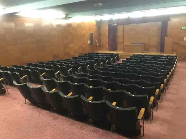 Wood-paneled theater auditorium in Kensington Central Library for lectures and presentations.
